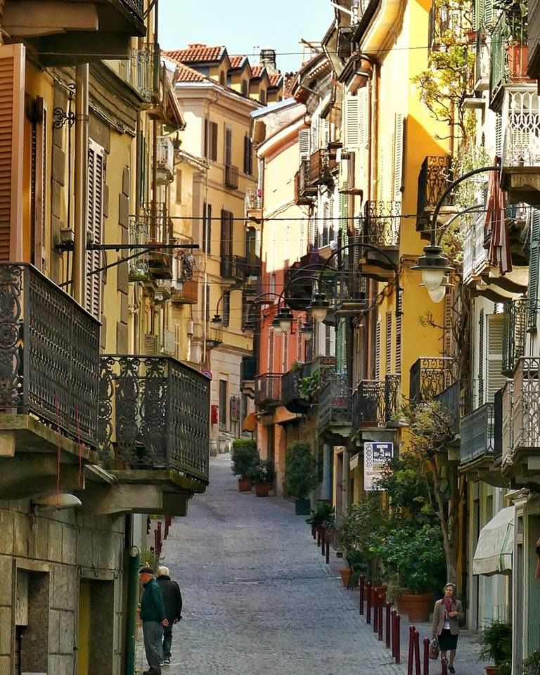 Cobbled street of residential buildings with balconies and shutters in a northern Italian town